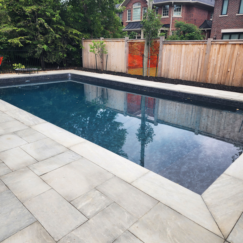 a swimming pool with a concrete deck