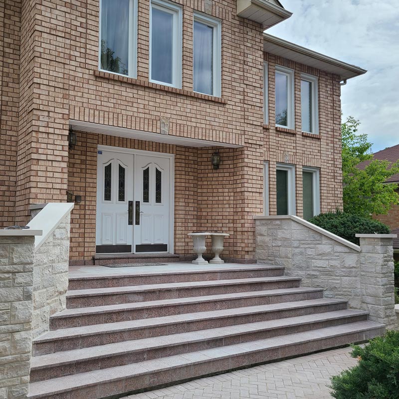 brick house exterior with natural stone stair railing